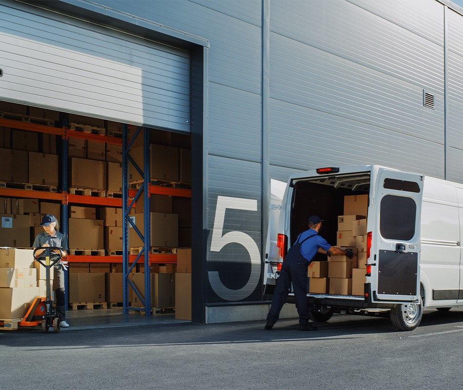 Man loading boxes into van from warehouse