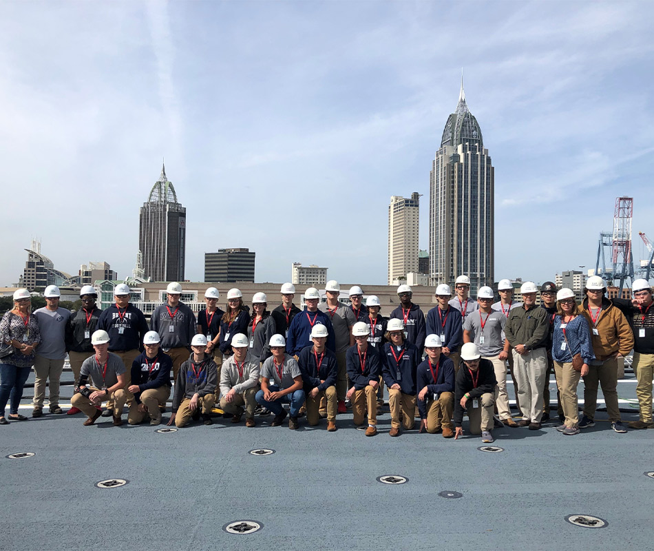 Group photo with Mobile skyline in background