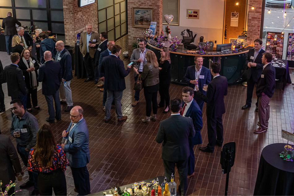 Guests mingling at Partners for Growth reception in Mobile Chamber lobby