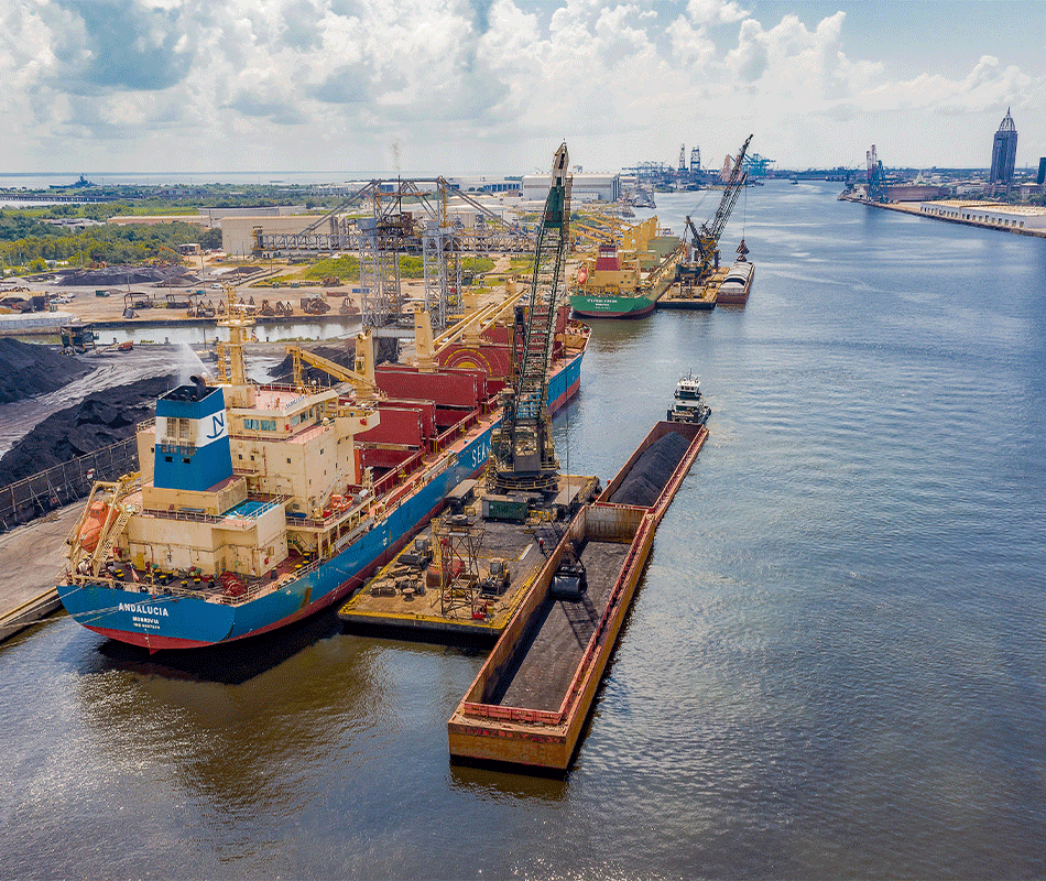 Mobile River arial view of barges and cranes docked.